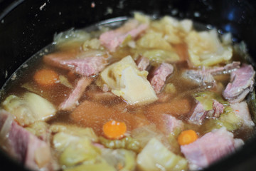 Delicious pot of corned beef stew with cabbage and carrots.
