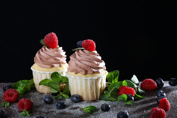 Handmade cupcakes on a black background. Still life concept
