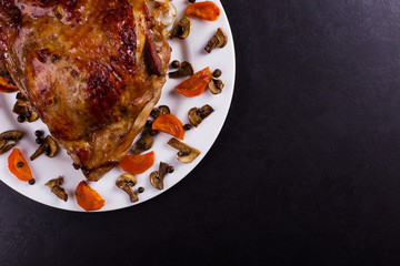 Thigh turkey baked in the oven with spices on black stone background. Healthy food. Thanksgiving dinner.