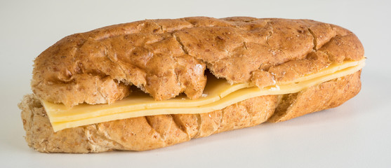 close up brown bun with cheese, on white table