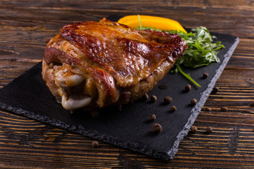 Thigh turkey baked in the oven with spices on black stone board. Healthy food. Thanksgiving dinner.