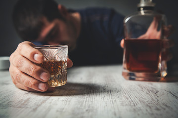 man hand whiskey bottle with glass