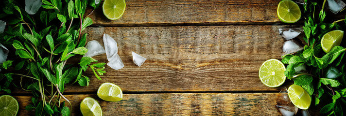 Fototapety  Mojito coctail ingredients with fresh mint leaves and lime slices on a wood background
