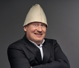 portrait of a businessman in hat bathhouse  smile