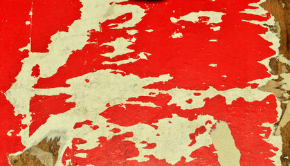 Red and white. The shreds of old posters on a billboard.
