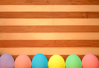 colorful pastel Easter eggs on wooden background
