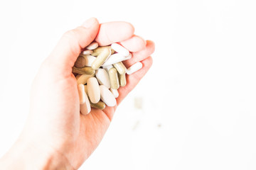 Vitamins in tablets. Pills in the hand. Copy space. White background