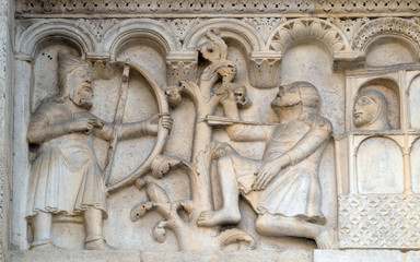 Plate with stories from Genesis: Blind Lamech kills Cain with an arrow in his throat, bass relief by Wiligelmo, Modena Cathedral, Italy