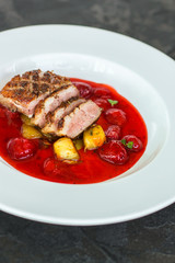 duck breast, vegetables, berry sauce and microgreen (main dish). food background. top view