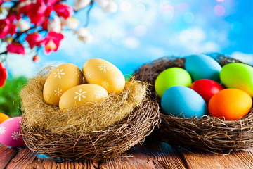 Easter eggs on wooden table and nature background