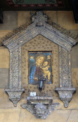 Virgin Mary with baby Jesus, house facade in Modena, Italy