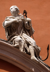 Symbols of Faith, statue on the portal of St. Barbabas Church, Italy 