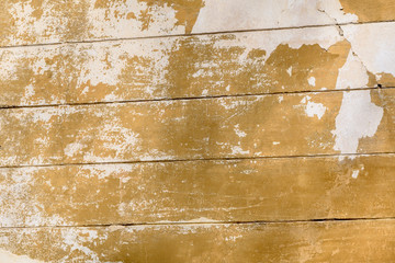 Background of an aged painted wall, with old dark yellow and white paint