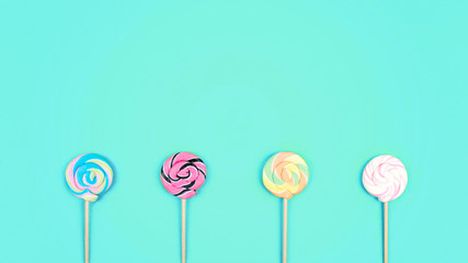 Many colorful lollipops on blue pastel background. Minimal modern party, festive background. Flat lay, top view