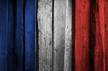 French flag on background of old wooden planks.