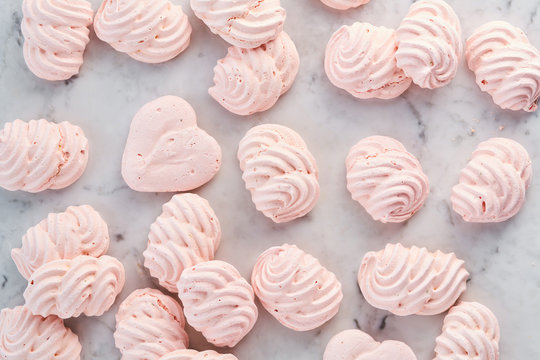 Meringues in rows on a marble table