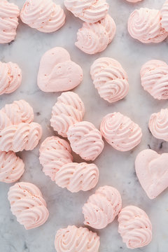 Meringues in rows on a marble table
