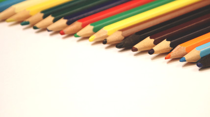 Fototapeta premium Colored pencils close up in macro photography. Art set of pencils with free space.
