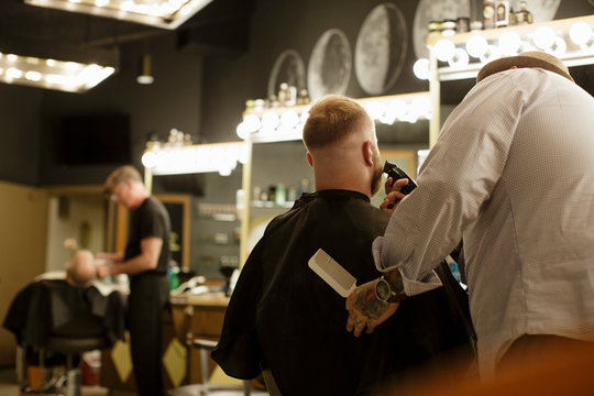 Rear view of barbers at work