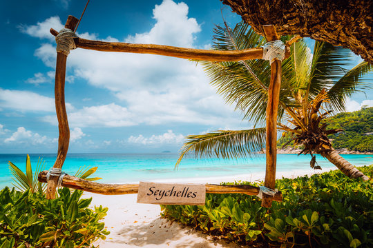 Amazing tropical scene with bamboo frame on the white sand beach against turquoise sea. Vacation in paradise. mahe Island, Seychelles