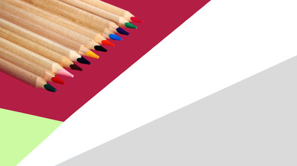 Obraz premium Colored pencils on a colorful background close up in macro photography.
