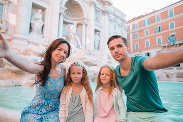 Happy family near Fontana di Trevi with city map