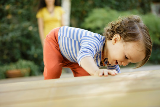 Toddler finds something exciting under deck