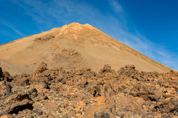 Majestic volcanic cone rising above spectacular lava shaped landscape.