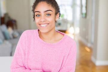 Beautiful young african american woman with afro hair with a happy and cool smile on face. Lucky person.