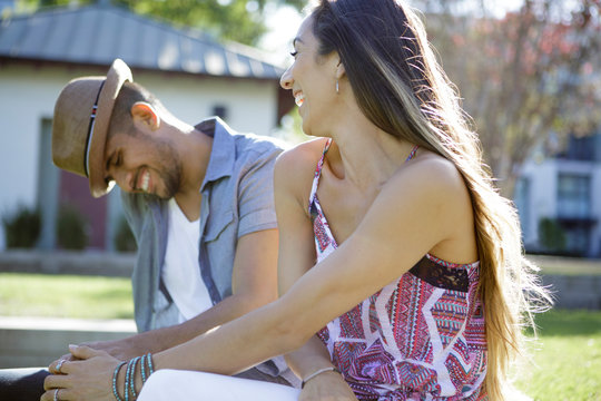 Young couple laughs outdoors