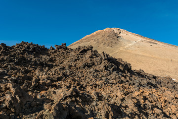 Majestic volcanic cone rising above spectacular lava shaped landscape.