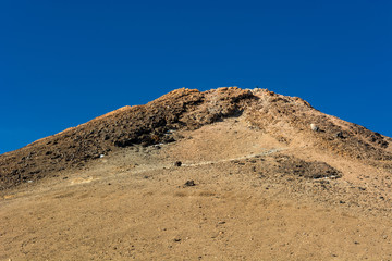Majestic volcanic cone rising above spectacular lava shaped landscape.