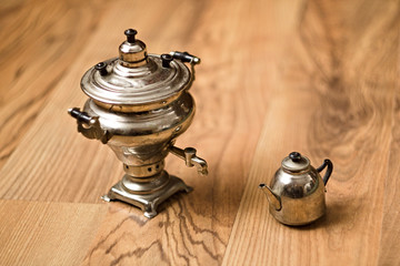 Toy Samovar and teapot on a wooden cutting board