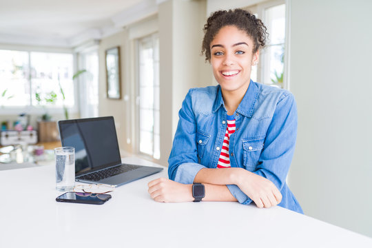 Young african american business woman working using computer laptop with a happy and cool smile on face. Lucky person.