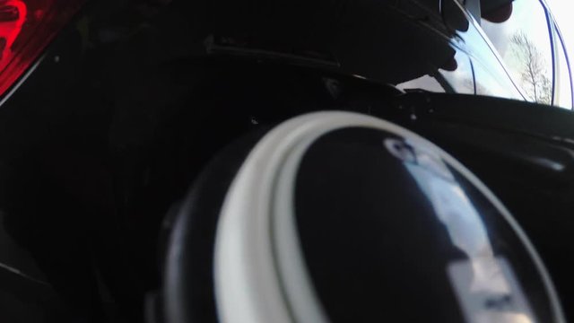 Car refueling at the petrol station with action cam on the nozzle. Concept for fossil fuels,air pollution and environmental