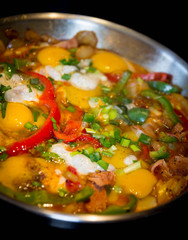 Fried eggs with tomatoes, onion and paper. Homemade breakfast shakshuka cooked in a frying pan. Breakfast recipe.