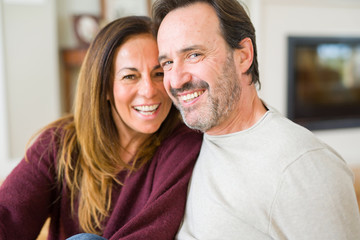 Beautiful romantic couple sitting together on the floor at home