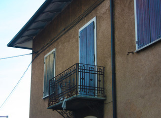 an old house with brown walls. dark blue wooden doors