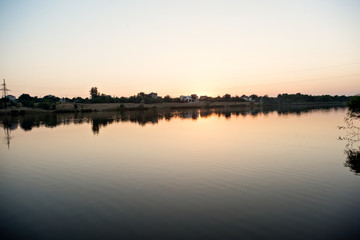 Fototapeta premium Beautiful sunset on the lake. Beautiful sunrise on the lake. Protect the environment!