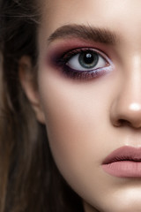 Fototapeta premium A girl with beautiful golden eye makeup and curly hair