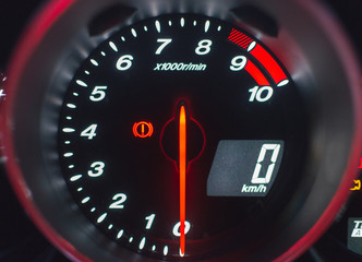 Close up shot of a speedometer in a car.