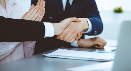 Business people shaking hands finishing up a meeting. Handshake at successful negotiation