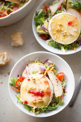 Salad with lettuce, fried pears, camembert, walnuts, red onion, tomatoes and raspberry vinaigrette dressing