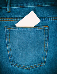 empty paper card is in the back pocket of blue jeans