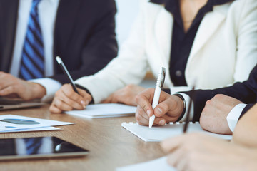 Group of business people or lawyers  work together at meeting in office, hands using tablet and...