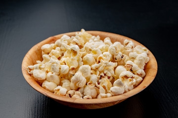 Popcorn on the kitchen table. Delicious roasted corn kernels.