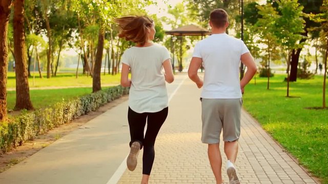 unrecognizable athletic people exercising together caucasian man and woman wears sportswear working out at summer morning