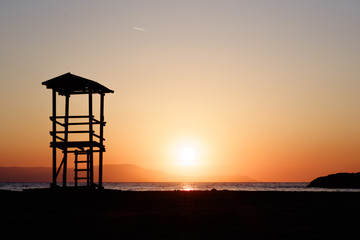 lifeguard tower silhouette on sunset