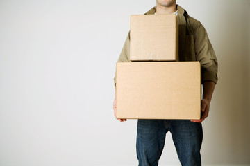 Moving: Anonymous Man Carrying Cardboard Moving Boxes