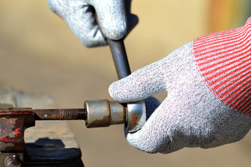 The wrench tightens the rusty nut.